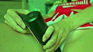 A cheerleader indulges in self-pleasure using a massage device