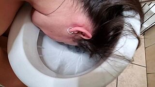 Kinky amateur indulges in toilet fetish by pissing and licking inside the toilet bowl