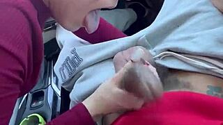 A Caucasian girl with shaved head performs oral sex in a vehicle