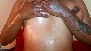 Horny black woman rubs her oiled big nipples