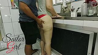 A young woman of a white background engages in sexual activities with a sailor in her kitchen