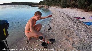 Sultry European beauty performs mesmerizing fire dance on nude beach at sunset