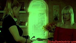 A redhead femdom lesbian uses a toy on her bound sub