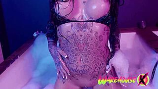 Tattooed beauty indulges in solo play in the pool