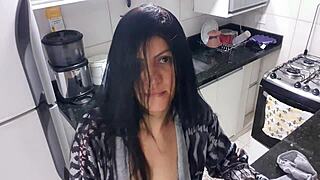 A seductive woman in the kitchen indulges in solo play