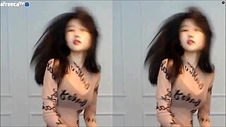 Asian cam girl shows off her moves and big tits in this steamy video