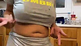 Anna Maria continues to dance and tease while washing the dishes.