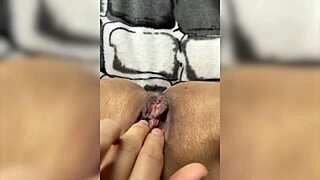 A naughty cat in pink leggings masturbates and exposes her pussy.