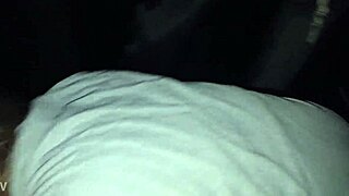 A white girl gives a blowjob to a black man in a car.
