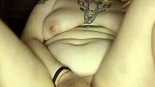 A petite blonde girl enjoys solo pleasure with a black toy
