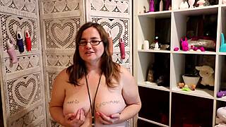 A big boobed woman shows off a female condom