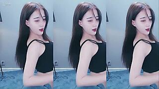 Pretty Chinese girl shows off her dancing skills with a vibrator