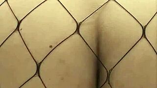 Voluptuous woman rides dildo in fishnet stockings