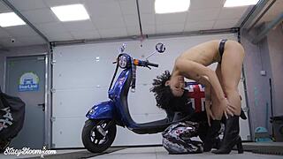 Close up of a naked brunette dancing to erotic music on a motorcycle