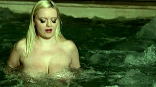 Interracial couple enjoys a steamy poolside massage session