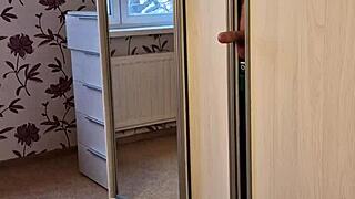 A girl-next-door amateur gives a blowjob to her partner while stuck in the wardrobe