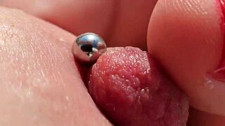 Close up of pierced nipples during a homemade video on the balcony