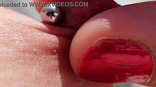 Close up of pierced nipples during a homemade video on the balcony