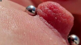 Close up of pierced nipples during a homemade video on the balcony