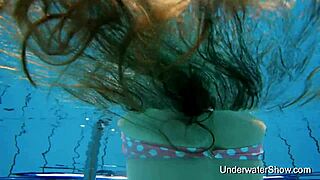 The sexy girl demonstrates her body in the water