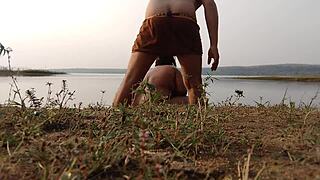 A sexy Indian woman bathes outdoors with her friend's help