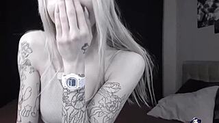 This inked camgirl teases with her hairless body and squirting climax